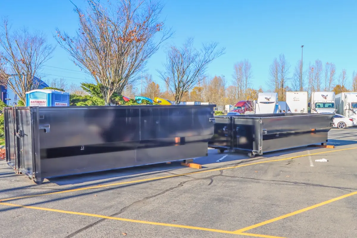 Professional dumpster rental service with roll-off container on residential driveway in Caernarvon